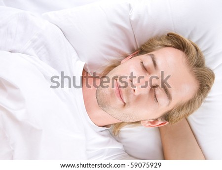 Young Man Sleeping in his Bed