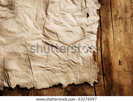 Old Paper sheet over wooden background closeup