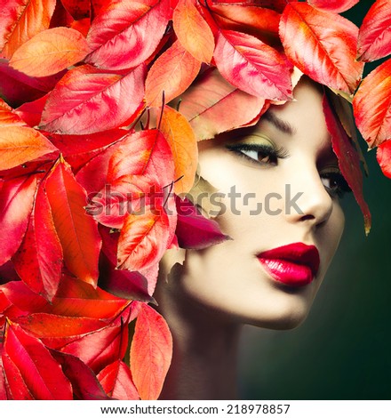 Autumn Woman Fashion Portrait. Fall. Beautiful Model Girl with colourful autumn leaves hairstyle. Red Autumn leaves Hair. Fashion Art design