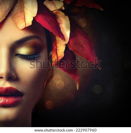Fantasy Autumn Woman Fashion Portrait. Fall. Beautiful Model Girl face with colourful autumn leaves hairstyle over dark background. Fashion border Art design over black with copyspace for your text