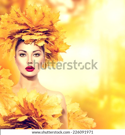 Autumn woman with yellow leaves hair style. Autumn Lady Portrait. Beauty Fashion Model Girl with Autumnal Make up and Hairstyle. Fall. Creative Autumn Makeup. Beautiful Face