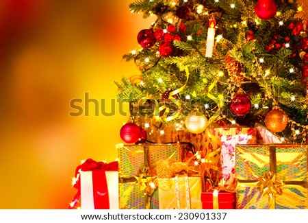 Decorated Christmas tree with various gifts. Christmas and New Year celebration. Holiday Christmas scene. Christmas gifts under the Christmas tree