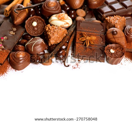 Chocolates border isolated on white background. Chocolate. Assortment of fine chocolates in white, dark, and milk chocolate. Variety of Praline Chocolate sweets