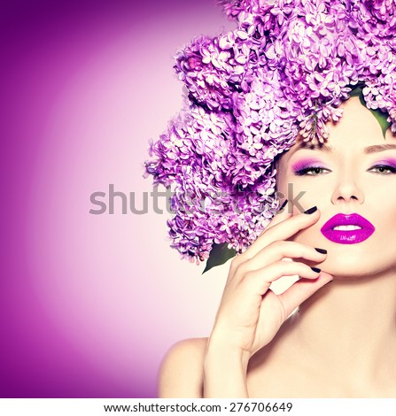 Beauty fashion model Girl with Lilac Flowers Hair Style. Beautiful Model woman with Blooming flowers on her head. Nature Hairstyle. Summer. Holiday Creative Makeup and manicure. Make up. Vogue Style