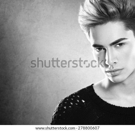 Fashion young model man portrait. Handsome Guy. Vogue style image of elegant young man. Black and white Studio fashion portrait.