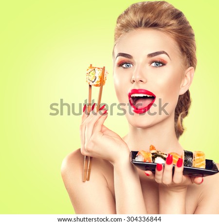Beauty Woman eating Sushi. Beauty Fashion model girl eating Sushi rolls. Chopsticks. Beautiful sexy surprised lady with perfect make up eating healthy japanese food. Diet, dieting concept
