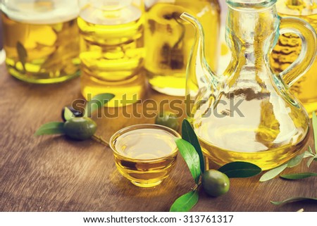 Oil olive in glass bowls. Oil olive with black and green olives over wooden table. Olives and Healthy extra virgin Olive oil bottle. Diet. Dieting concept. Healthy food