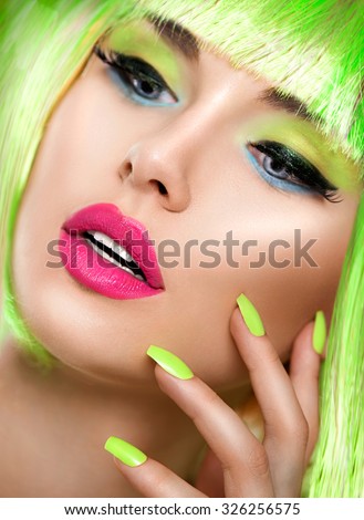 Beauty Girl face with Vivid Makeup and bright green Nail polish. Vivid nails. Fashion Woman portrait close up. Bright Colors. Long eyelashes,  electric green eyeshadows make up