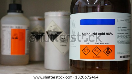 Bottle of Sulfuric Acid, H2SO4 with Properties information and its chemical hazard warning symbols. Corrosive hazard symbol, Inhalation hazard symbol and Toxic symbol Сток-фото © 