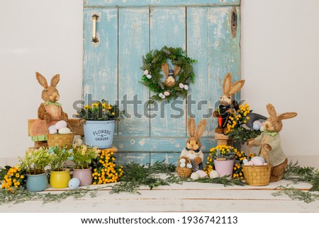 Easter backdrop or background for photo mini session in blue color. Contains straw rabbits and eggs basket. Stock foto © 