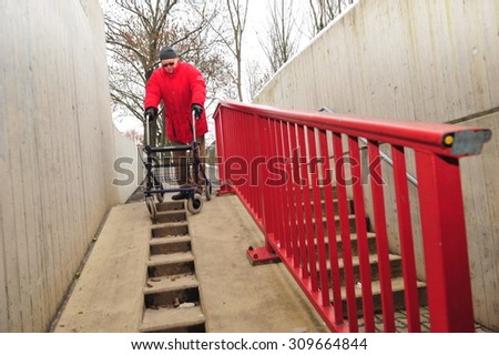 Worms, Germany - December 1, 2010: Old man having difficulties to move barrier-free though his city