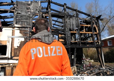 Frankfurt, Germany - April 4, 2009 -  Police officers examine house destroyed by fire caused by a cigarette