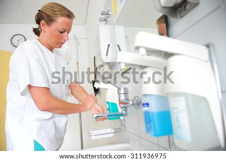 Frankfurt, Germany - September 17, 2009 - Doctor washing hands in hospital to avoid infections