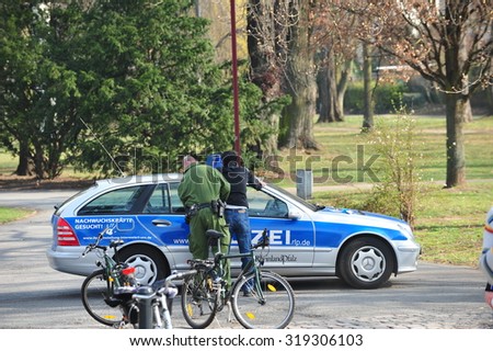 Frankfurt, Germany - March 24 2010 - Police men controlling dealers in a park, heroine splashes