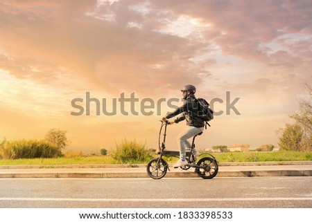 Similar – Image, Stock Photo Foldable bike by the ocean at sunset