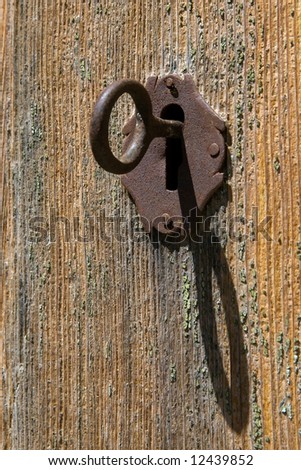 Lock and key in an old wooden door
