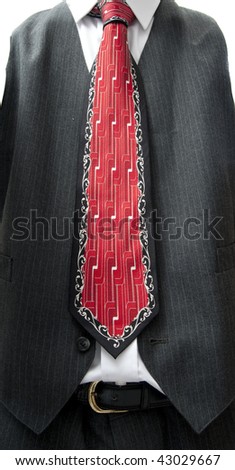 CLOSEUP OF VEST AND RED TIE WITH GEOMETRIC LINEAR DESIGN