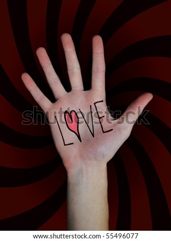 The word love written on a teenager\'s white Caucasian hand isolated on black background.