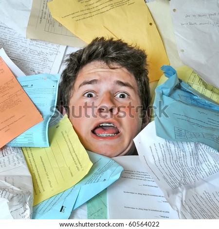 Young male student is overwhelmed by way too many homework assignments.