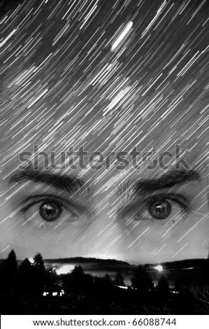 Star trails long exposure at night. Concept photo demonstrating believers of UFOs, alien lifeforms, and extraterrestrial beings.Copyspace above the eyes.