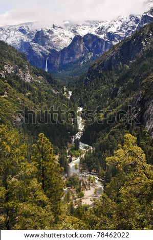 Snow on top of the mountain melts off and falls off the mountain as a water fall as it then transforms into a river and stream going into the forest. Yosemite national Park, California.