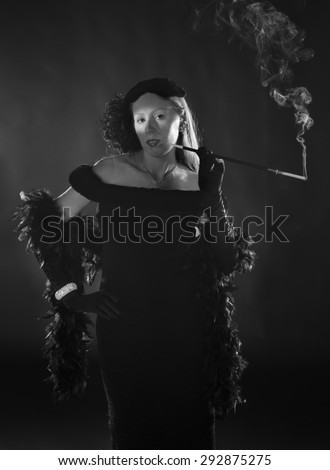 Elegant Black and White Portrait of Glamorous Woman Smoking Cigarette and Dressed in Vintage Clothing, Three Quarter Length Portrait in 1940s Film Noir Style