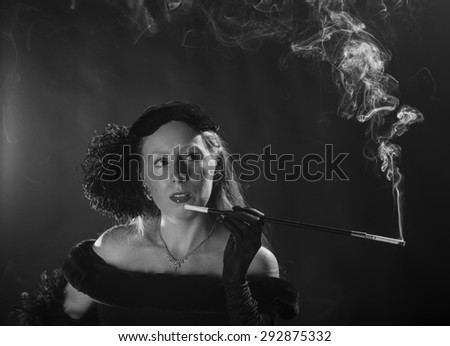 Elegant Black and White Portrait of Glamorous Woman Smoking Cigarette and Dressed in Vintage Clothing, Head and Shoulders Portrait in 1940s Film Noir Style