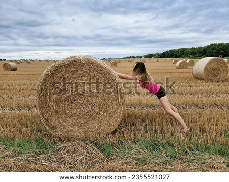 Image, Stock Photo Woman Pushing Hay Bale