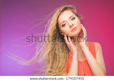 Hair in the wind. Fluttering long curls. Colorful background.