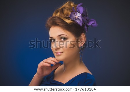 Photo of a young woman with flowers. Plus size model. Flower decoration in her hair.