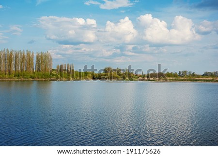 Rural landscape - river bank of the river and clouds