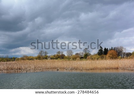 Landscape - storm clouds over the coast of the river