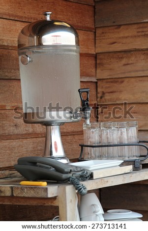 Glass water cooler contain cold water and ice inside.