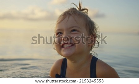 Similar – Image, Stock Photo portrait of beautiful baby girl at home sitting on the sofa playing with a garland of lights