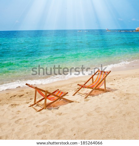 Two lounge chairs on the beach