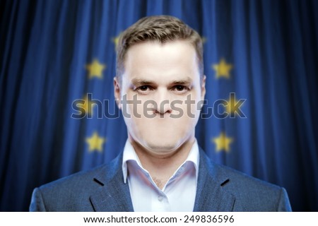 Symbol of censorship and freedom of speech: a young man without a mouth on a background of the flag of Europe (EU)