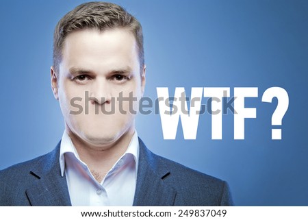 Serious young man without a mouth on a blue background with the words:WTF?