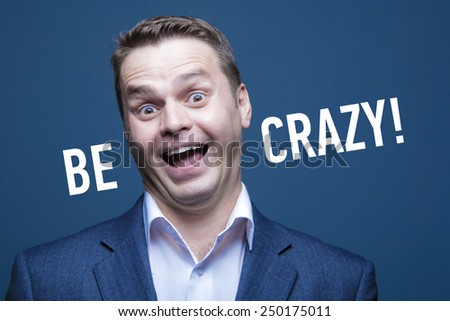 Funny young man with words: Be Crazy!