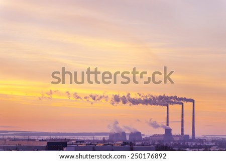 View of the factory with smoking chimneys