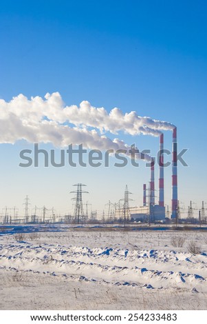 Smoking chimneys against the blue sky