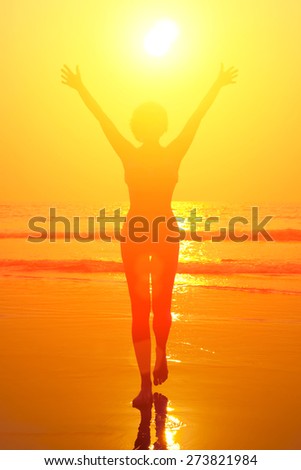 Figure of a woman on the background of the sea nd sunset.