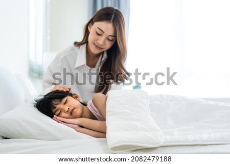 Similar – Image, Stock Photo Mom puts a child a mask and escorts to school or kindergarten. A boy with a masked backpack during a coronavirus. Side view