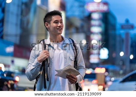 Similar – Image, Stock Photo Asian man with travel bag using smartphone against white wall