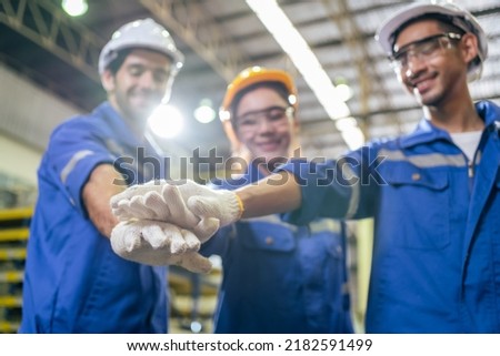 Group of young industrial people worker work in factory with happiness. Attractive manufactory engineer man and woman stack hands for motivate and work unity teamwork at manufacturing plant warehouse. Stockfoto © 