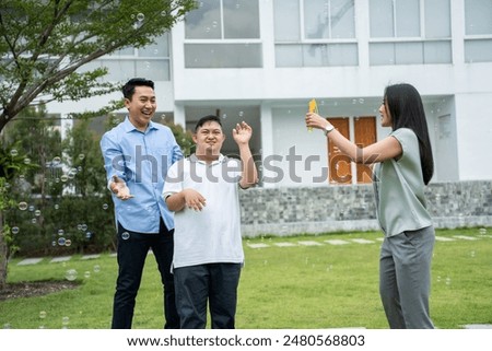 Similar – Image, Stock Photo Boy with special needs water color painting with both hands at the same time; AAC communication device sits nearby