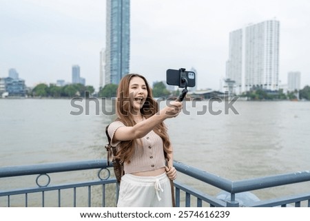 Similar – Image, Stock Photo Woman with backpack taking selfie on smartphone on background of mountains