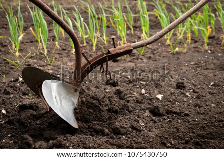 Hand plow on the field. Plowing the ground before sowing. Close-up. 商業照片 © 