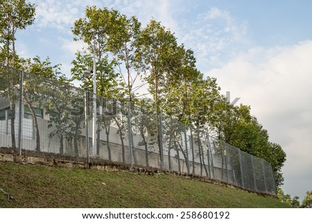 Security fencing with surveillance camera at residential neighborhood