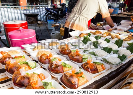 Vendor selling cuisine at street bazaar in Malaysia catered for iftar during Muslim fasting month of Ramadan