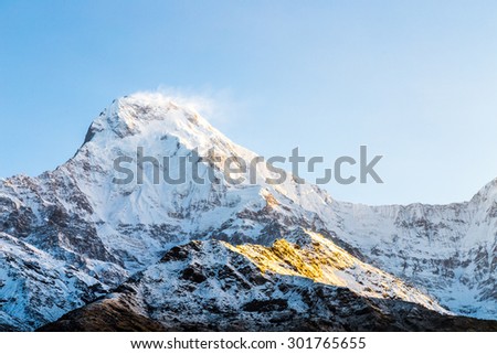 Sunrise rays on the snow-capped peak of Annapurna South from Tadapani, Nepal